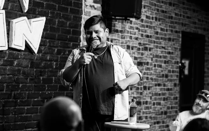 Ronnie Rohrbeck performing stand-up, black and white